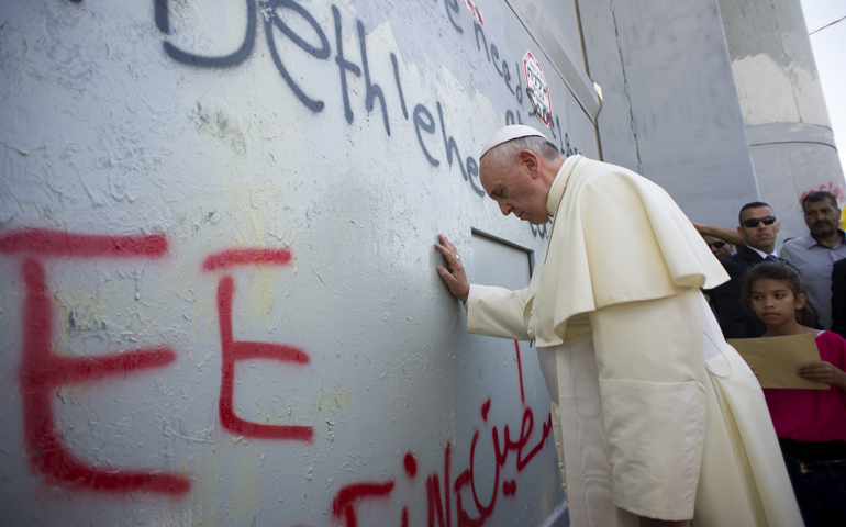 Pope Francis stops in front of the security wall dividing Israel and the Palestinian territories Sunday in Bethlehem, West Bank. (CNS/L'Osservatore Romano, pool)