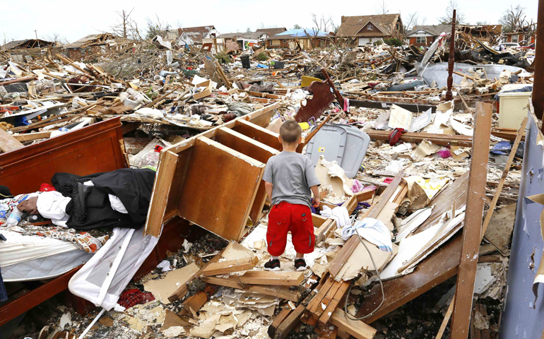 Timothy Stephan, 3, looks for his bed in the rubble of his tornado-destroyed home May 23 in Moore, Okla. The tornado was the strongest in the United States in nearly two years and cut a path of destruction 17 miles long and 1.3 miles wide. (CNS/Reuters/Rick Wilking)