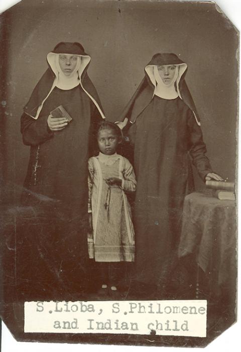 Benedictine Srs. Lioba Braun and Philomena Ketten pose for a photograph with a child presumed to be from the Ojibwe Tribe in the 1880s. Braun and Ketten were part of St. Benedict's Mission for members of White Earth Nation in Minnesota. ("Sisters Lioba Braun and Philomena Ketten with Ojibwe child," College of Saint Benedict/Saint John's University Libraries, https://csbsjulib.omeka.net/ items/show/923)