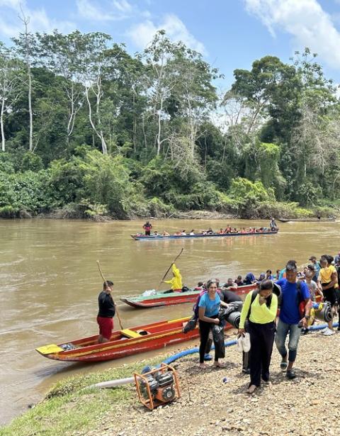 Lajas Blancas, Panama. Small boats pull to river shore, as people step onto land.