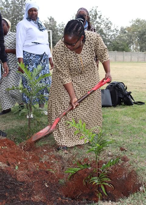 Damaris Mathusi, alongside students at Tangaza University in Nairobi, Kenya, plants trees in August 2024, following her session on community engagement for transformative development. (Courtesy of Damaris Mathusi)