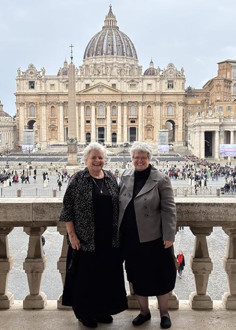 Benedictine Srs. Esther Fangman, left, and Lynn McKenzie stand in front of St Peter’s Square at the Vatican in November 2024 after their visit to the Dicastery for Institutes of Consecrated Life and Societies of Apostolic Life. (Courtesy of Lynn McKenzie) 