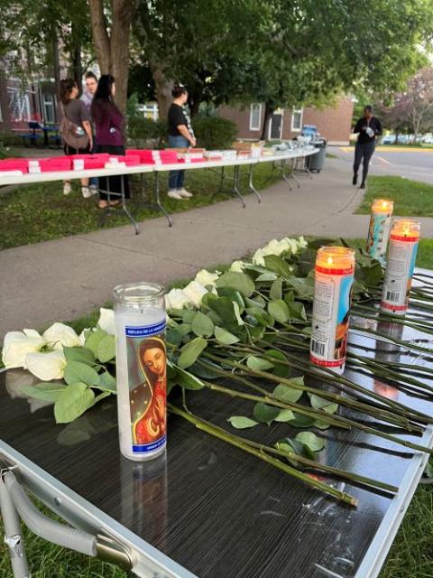 Candles and white roses honor victims at vigil. Candles and white roses honor victims at vigil.