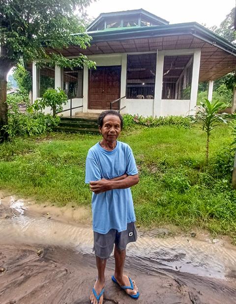 Junior Mercado, a member of the Aeta community, stands in front of the Catholic chapel near his home. (Oliver Samson)