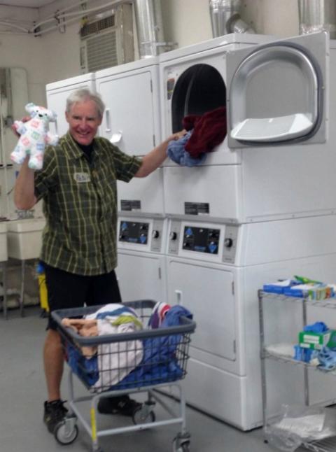 Peter Wise, a volunteer from the San Francisco Bay Area, helped with the essential behind-the-scenes work at Annunciation House in El Paso, Texas: washing tons of bedding, clothing and, occasionally, a stuffed animal. (Petrina Grube) Peter Wise, a volunteer from the San Francisco Bay Area, helped with the essential behind-the-scenes work at Annunciation House in El Paso, Texas: washing tons of bedding, clothing and, occasionally, a stuffed animal. (Petrina Grube)