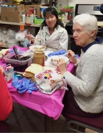 Sisters take a break from making sandwiches. Sisters take a break from making sandwiches.