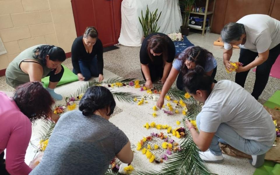 Women create a flower mandala as a symbol of gratitude for beginning their psycho-spiritual accompaniment process. (Flight in V Formation)