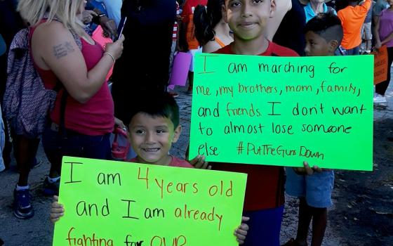 Two boys show their signs for a July 7 march against gun violence in Chicago. (Laurette Hasbrook)
