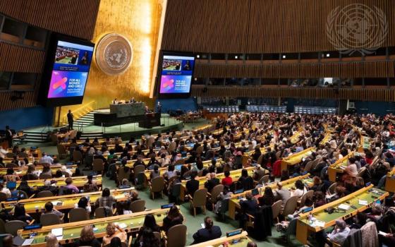 Sima Bahous, executive director of UN Women, appears onscreen at the United Nations' General Assembly Hall during a town hall meeting with the U.N. secretary general and civil society at the 69th session of the Commission on the Status of Women. (UN/Evan Schneider)