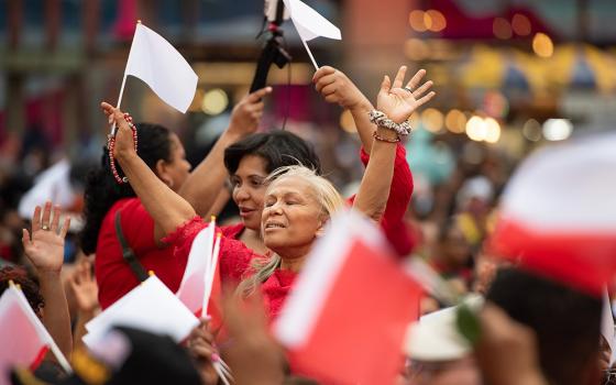 A woman prays during a eucharistic procession through the Manhattan borough of New York City to St. Patrick's Cathedral for a Pentecost Vigil May 27, 2023. (OSV News/Jeffrey Bruno)