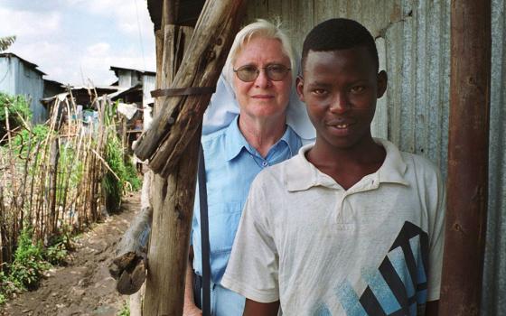 Mercy Sr. Mary Killeen from Ireland stands behind Benjamin Alenga Luvai, a former street boy and chairman of the Gap Centre for street boys in Nairobi, Kenya in this 2001 photo. (CNS/Declan Walsh) 