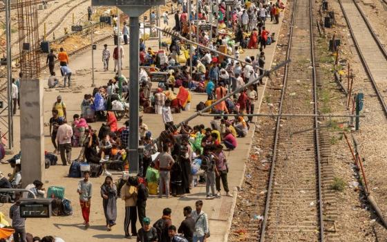 people on train platform in India
