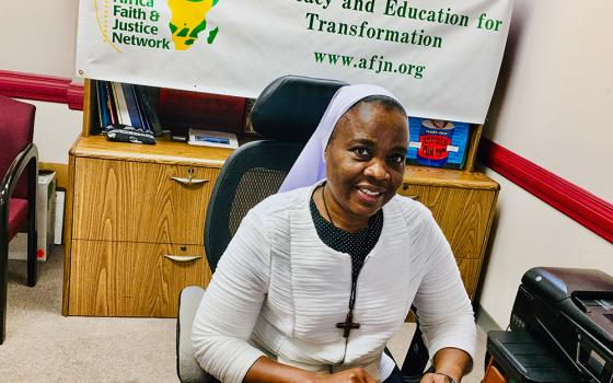 Notre Dame de Namur Sr. Eucharia Madueke poses in her office in Washington, D.C. Madueke is the coordinator of the Africa Faith and Justice Network's Women Empowerment Project. In her role, she works with sisters across Nigeria, training and mobilizing them to raise awareness about gender-based violence, human trafficking and harmful cultural practices. (Courtesy of Eucharia Madueke)
