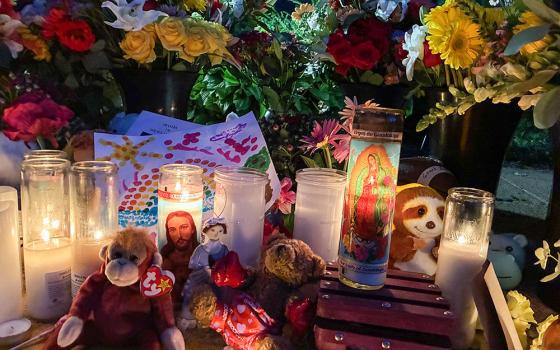 Candles, flowers and stuffed animals are seen in a community memorial outside Annunciation Catholic Church in Minneapolis Aug. 28, 2025. (OSV News/Maria Wiering)
