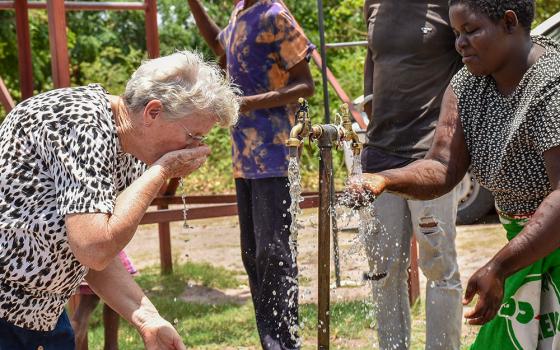 Presentation Sr. Cathy Crawford, left, and Winnie Liywali, right, inspect a borehole in Mwanambinyi, Zambia. (Derrick Siliminia)