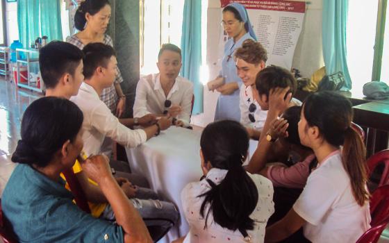 Sr. Marie Magdalene Duong Thi Nguyet of the Daughters of Mary of the Immaculate Conception listens to high-risk individuals share their struggles at Kim Long Charity Clinic in Hue, Vietnam, on Oct. 11, 2025. (GSR photo)