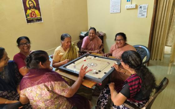 Nazareth Srs. Anice Vattukulam and Nisha Chemmanam (center) play carrom with the members of Asa Nilayam Pakal Veedu (Abode of Hope Day Home), a home for the elderly at Kallanode, a village in the Kozhikode district of Kerala, southwestern India. (George Kommattam)