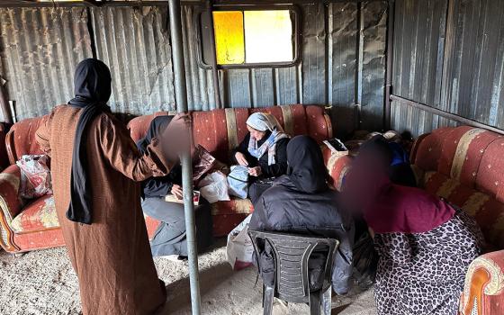 Women meet at the Tabana Bedouin camp near Al-Azariyeh, in the West Bank, for a "Threads of Peace" embroidery workshop on Feb. 28, 2026, as part of the Comboni sisters' accompaniment of Bedouin communities living with daily uncertainty. Sr. Cecilia Sierra is pictured, white veil, center. The image is obscured to protect identity. (Courtesy of Sr. Cecilia Sierra) 