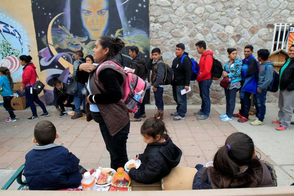 Migrants in El Paso await transportation to emergency shelters. Migrants in El Paso await transportation to emergency shelters.